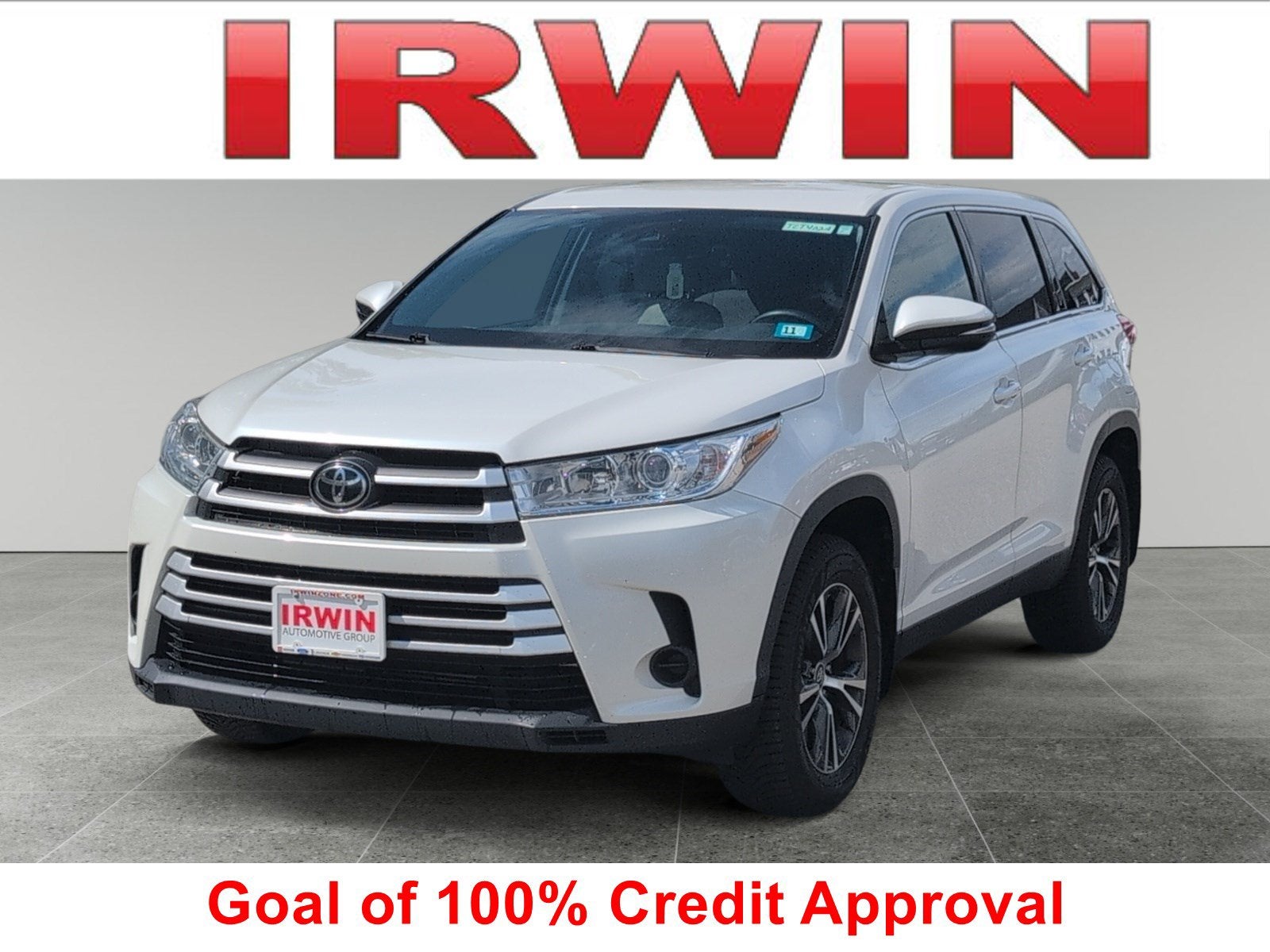 2019 Toyota Highlander LE in White — front three-quarter view